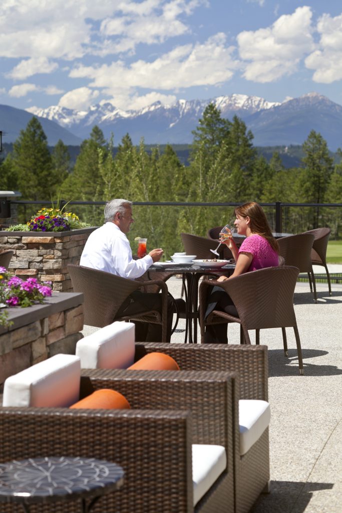 Two people sitting at an outdoor table at Copper Point Resort Hotel
