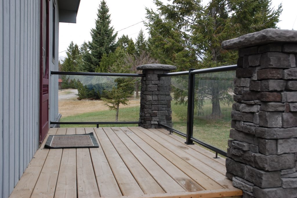 Wood deck with tempered glass railings