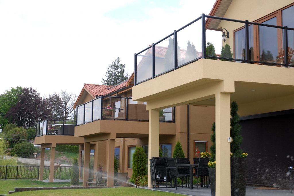 Houses with matching glass railing systems that maximize visibility