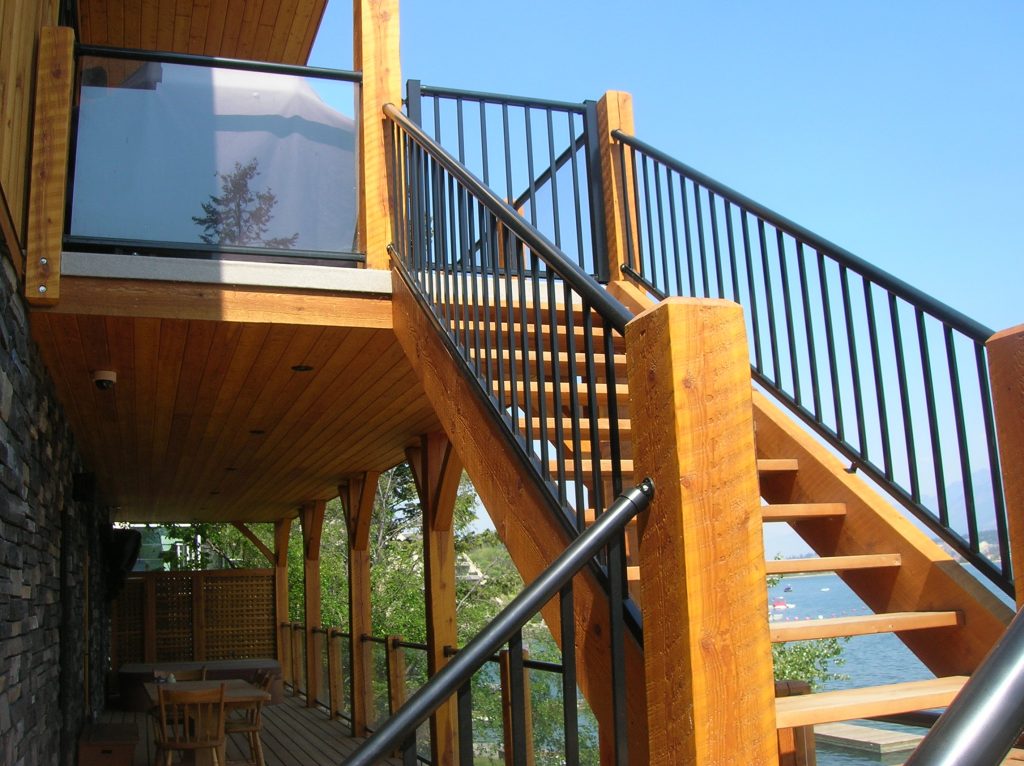 Wood staircase with black picket railing