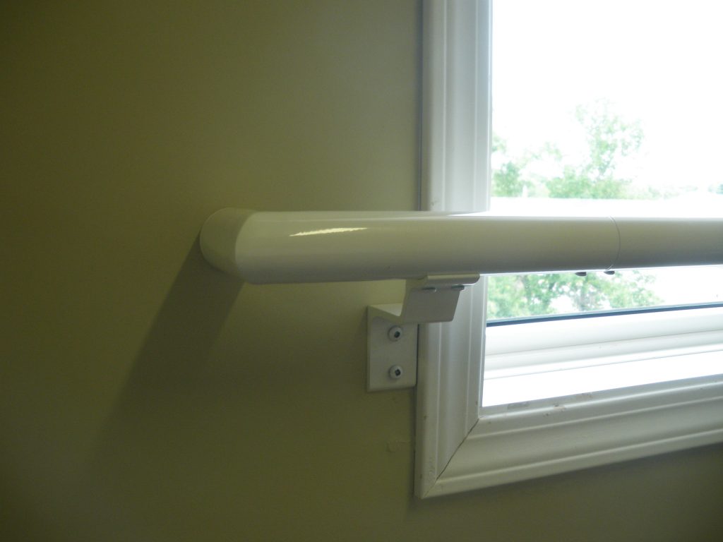 Pipe handrail going overtop of a window