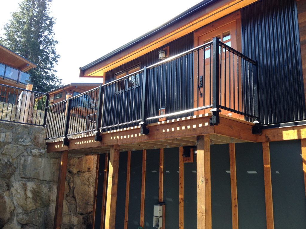 Home in Port Renfrew with black deck picket railings with fascia mounting