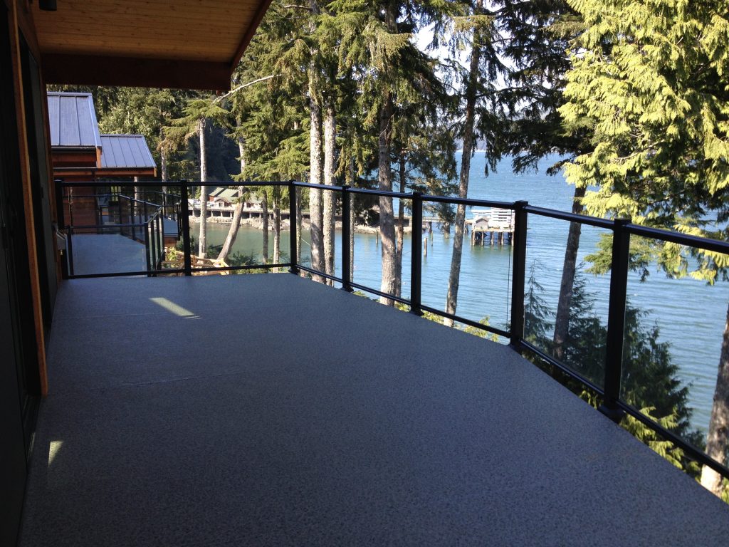 Fascia mount glass railing sections creating a spacious deck surface