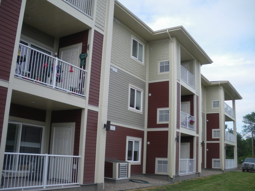 Multi family apartment building with white picket railings