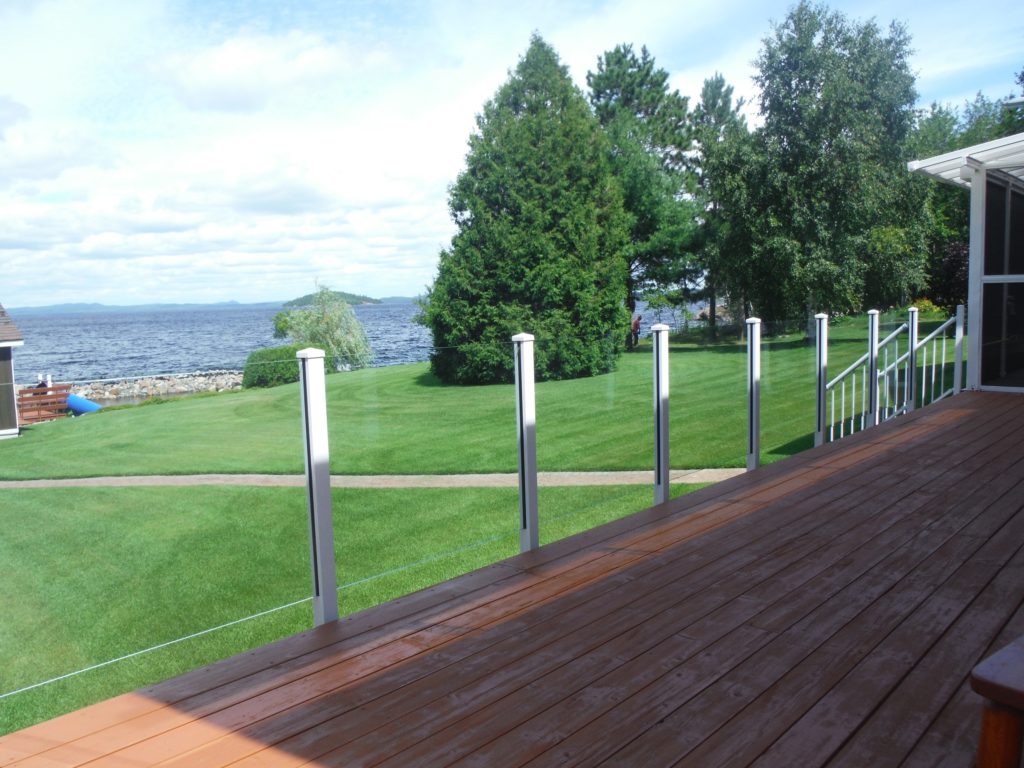 Frameless glass railing with fascia mount deck railing